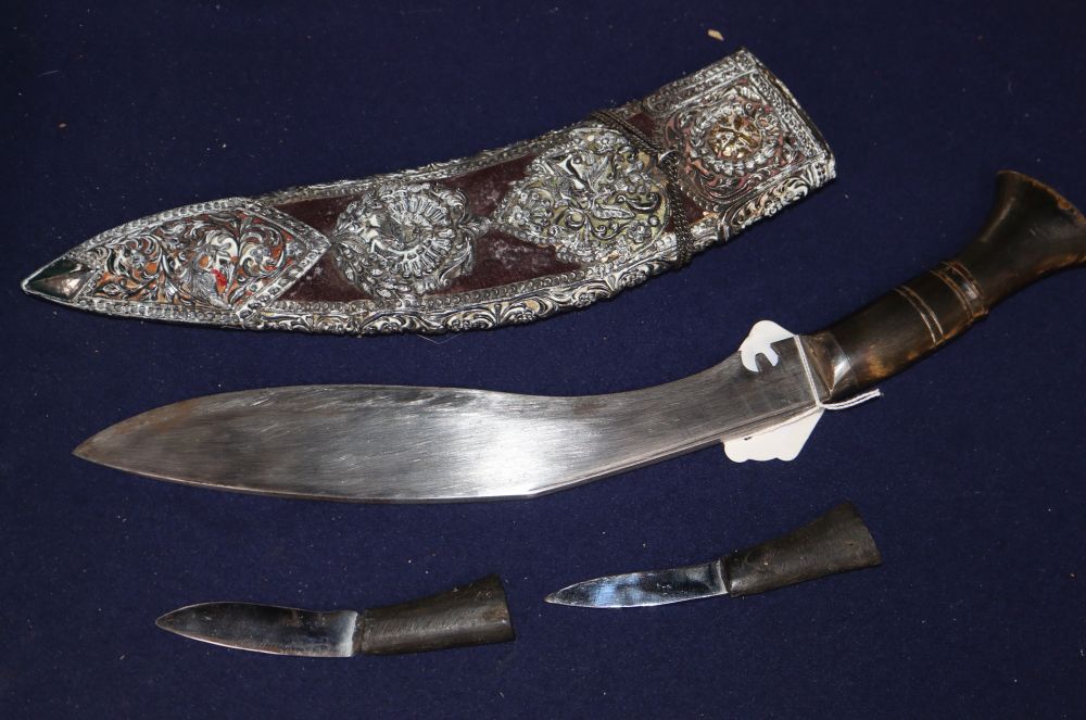 A late 19th century horn handled kukri, with white metal mounted velvet sheath